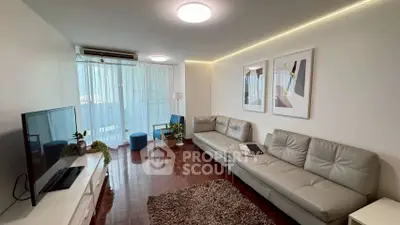 Modern living room with sleek furniture and natural light, featuring a cozy ambiance and stylish decor.