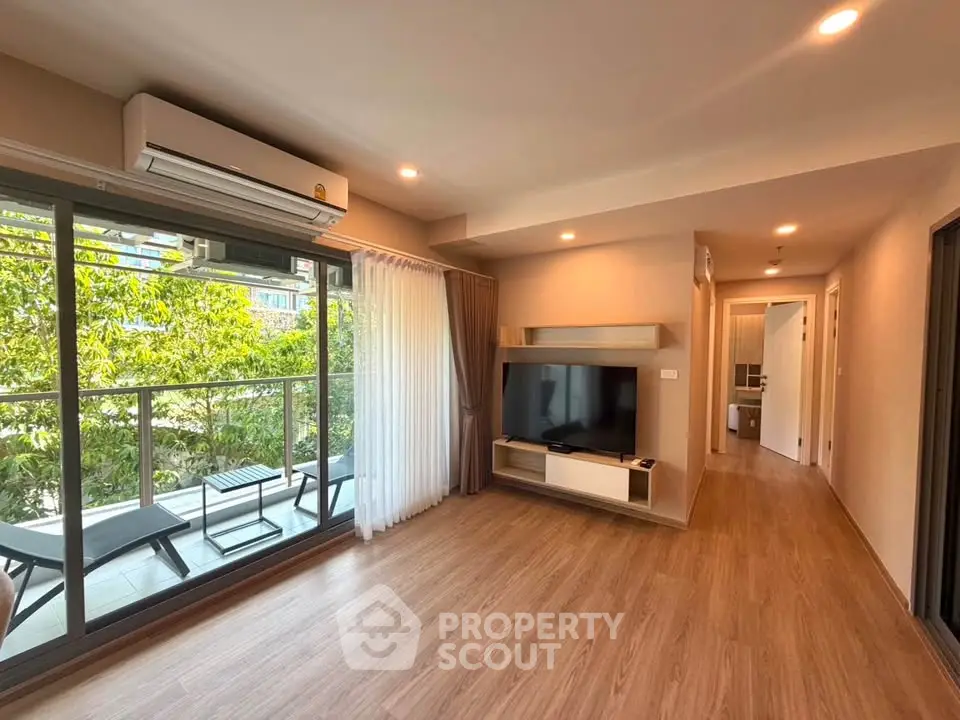 Spacious living room with balcony view in modern apartment