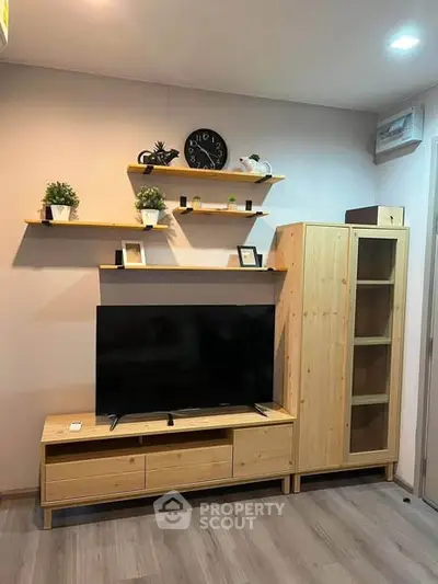 Modern living room with stylish wooden furniture and wall-mounted shelves.
