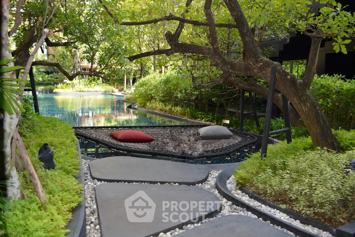 Luxurious garden view with serene pool and cozy seating area