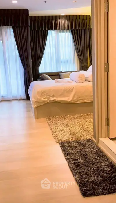 Luxurious bedroom with elegant curtains and cozy decor in modern apartment