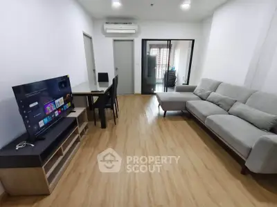 Spacious modern living room with sleek furniture and entertainment setup