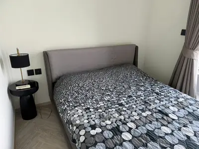 Cozy bedroom with modern decor and stylish bedding in a contemporary apartment.