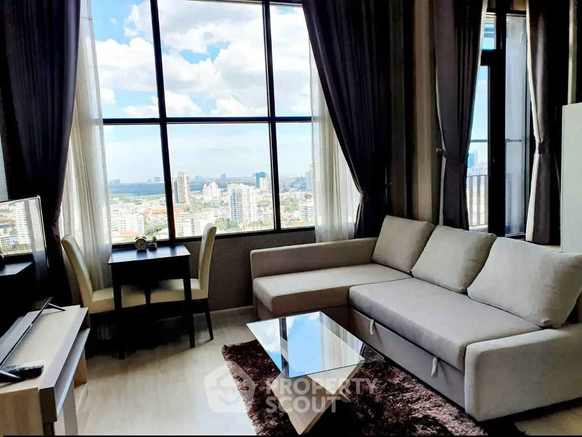 Luxurious living room with stunning city view, modern furniture, and floor-to-ceiling windows in high-rise apartment.
