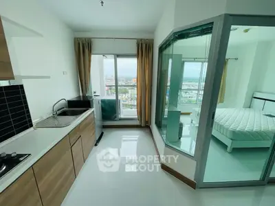 Modern apartment with open kitchen and bedroom, featuring city view.