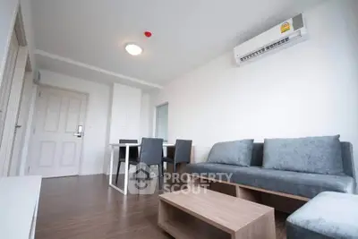 Modern living room with sleek furniture and air conditioning in a stylish apartment.