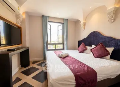 Luxurious bedroom with elegant decor and city view, featuring a plush bed and modern amenities.