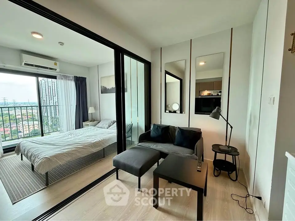 Modern apartment with glass partition, cozy living area, and city view from the bedroom.