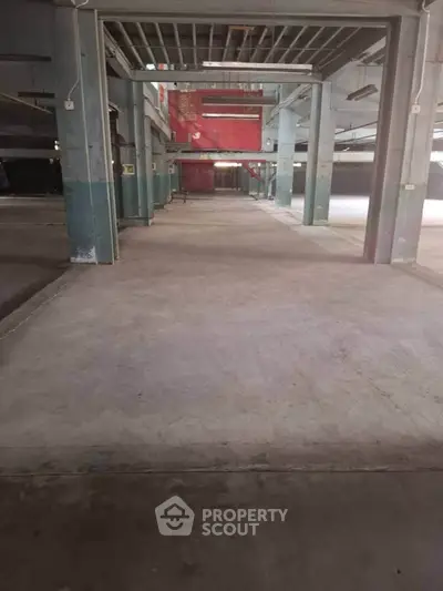 Spacious industrial warehouse interior with high ceilings and open floor plan.