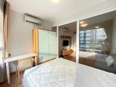 Modern bedroom with large window, air conditioning, and stylish furniture in a bright apartment.