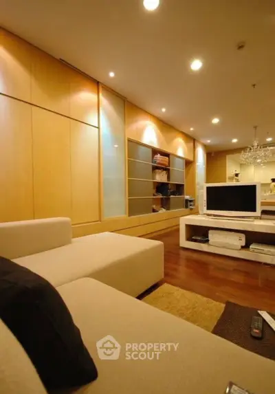 Modern living room with elegant lighting and sleek entertainment center.