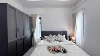 Modern bedroom with stylish decor and ample natural light