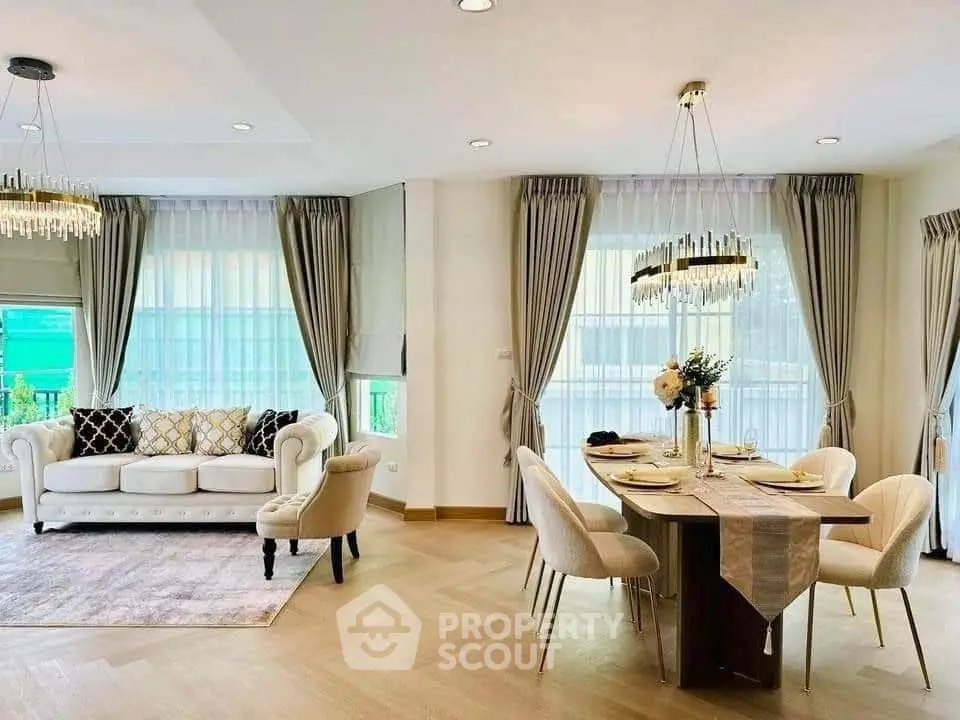 Elegant living and dining area with modern decor and large windows