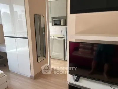 Modern studio apartment with sleek kitchen and cozy living area, perfect for urban living.