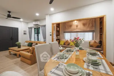 Spacious open-plan living and dining area with modern decor and cozy ambiance.
