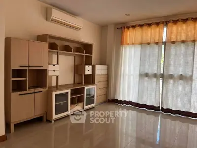 Spacious living room with modern furniture and large windows for natural light.