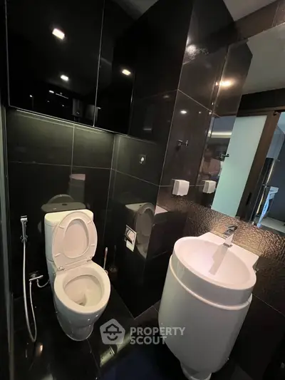 Modern bathroom with sleek black tiles and contemporary fixtures