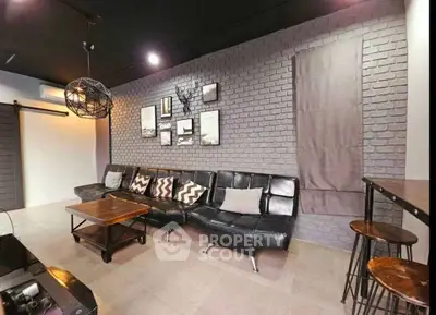 Stylish modern living room with brick accent wall and chic furniture
