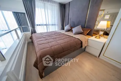 Luxurious bedroom with elegant decor and large windows offering natural light.