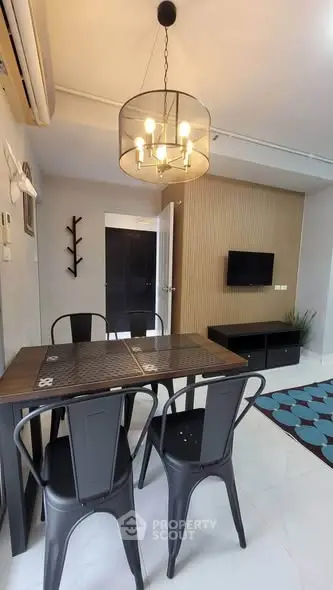 Modern dining area with stylish lighting and sleek furniture in a contemporary apartment.