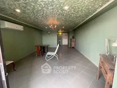Spacious living room with unique ceiling design and modern furniture