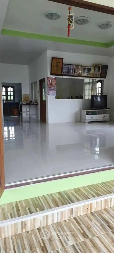 Spacious living room with modern decor and large windows for natural light.