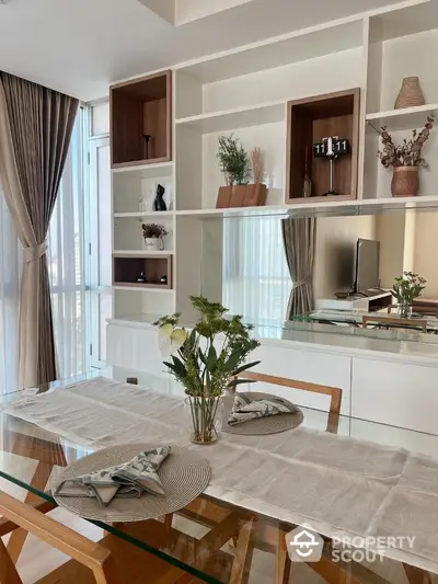 Elegant dining area with glass table and modern decor in a stylish apartment