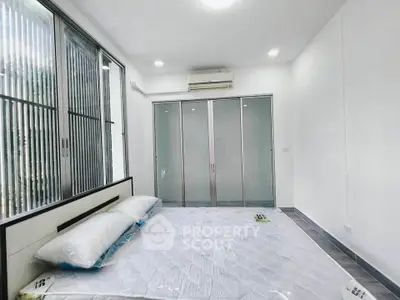 Spacious bedroom with large windows and modern sliding doors