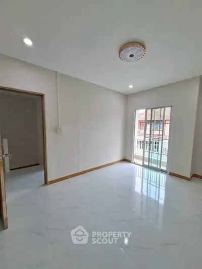 Bright and spacious room with large window and balcony access, perfect for modern living.