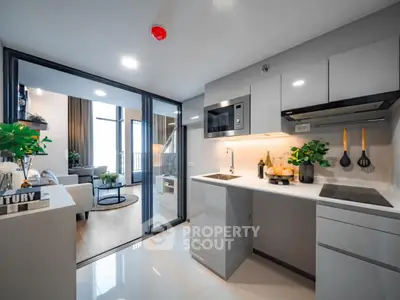 Modern open-concept kitchen and living room with sleek design and natural light