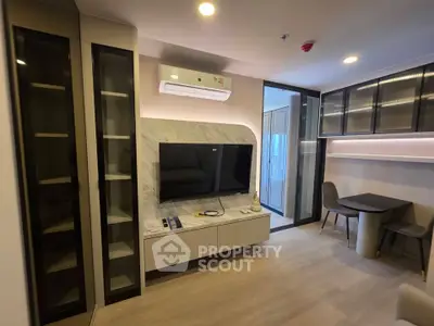 Modern living room with sleek TV unit and dining area in stylish apartment