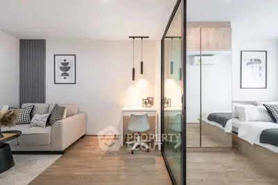 Modern studio apartment with stylish decor and open layout, featuring a cozy living area and bedroom.
