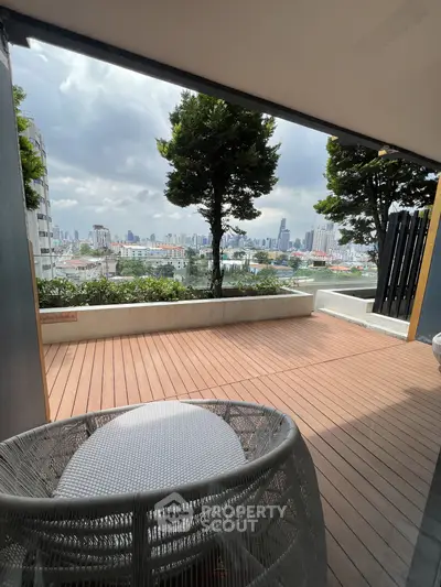 Spacious balcony with stunning city skyline view, perfect for relaxation and entertainment.