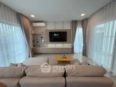 Spacious modern living room with elegant decor and large windows