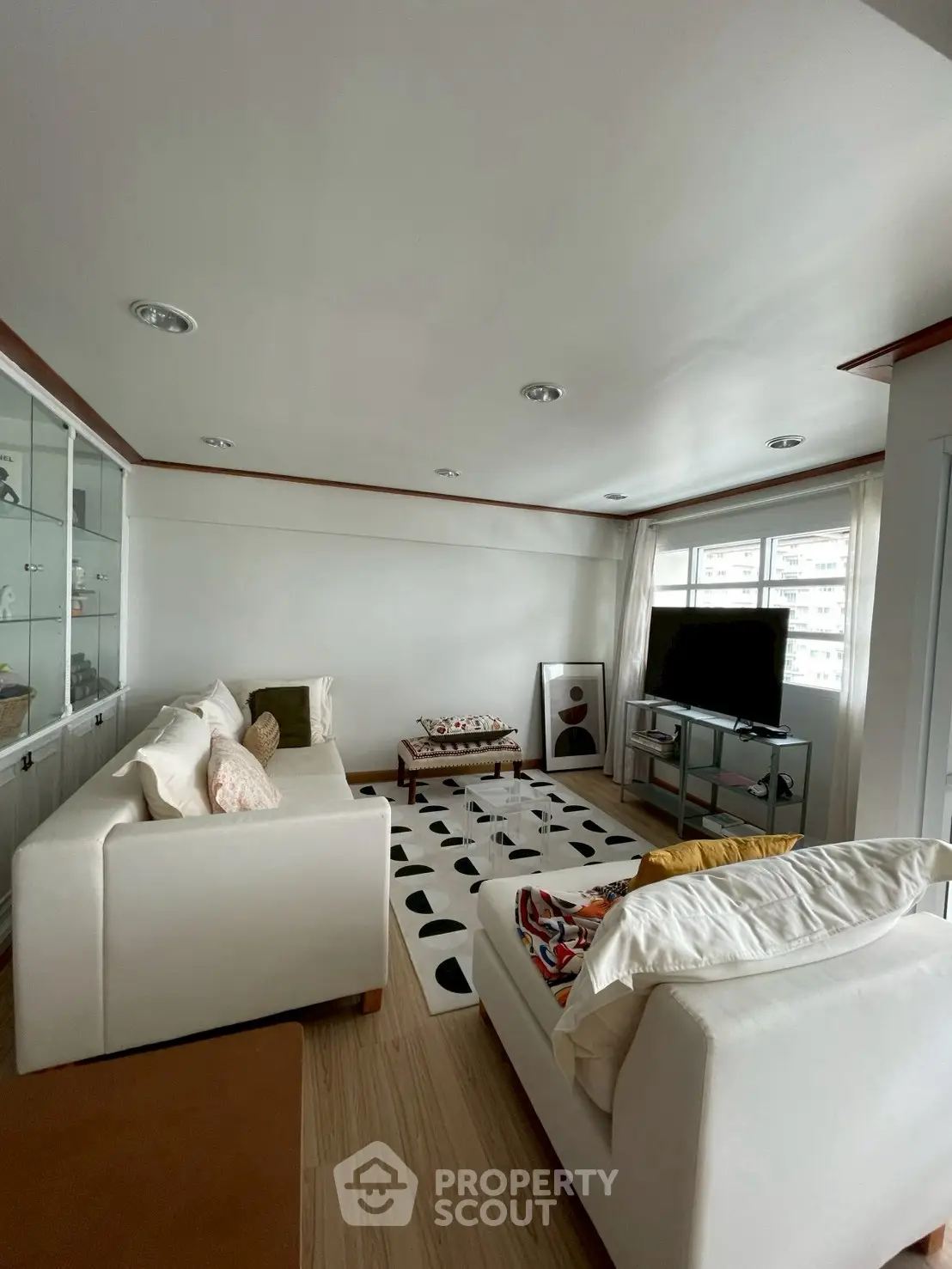 Spacious living room with modern decor and large windows for natural light.