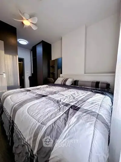 Modern bedroom with stylish decor and ample natural light