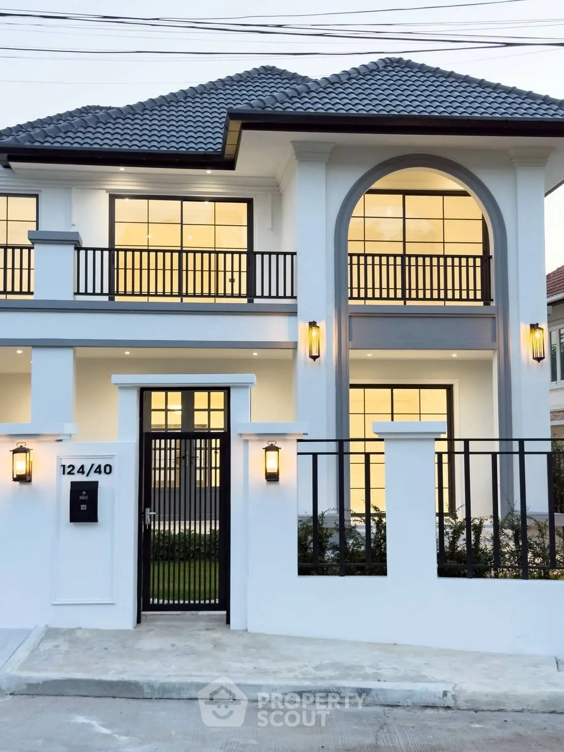 Stunning modern two-story house with elegant facade and large windows, perfect for luxurious living.