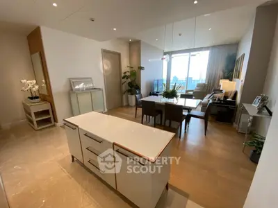 Luxurious open-plan living and dining area with modern decor and city view.
