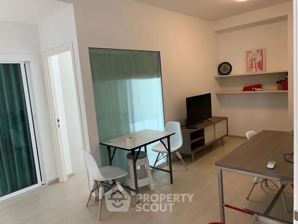 Modern living room with sleek furniture and natural light, perfect for urban living.