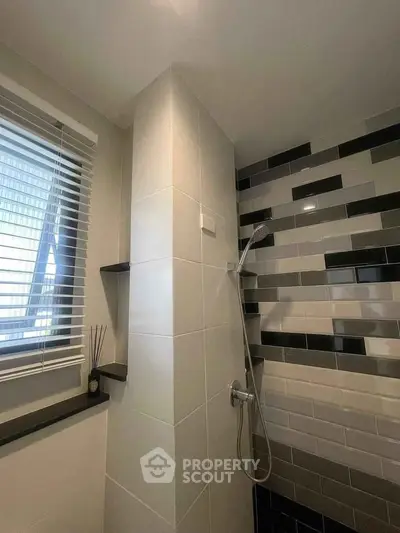 Modern bathroom with sleek tile design and shower area