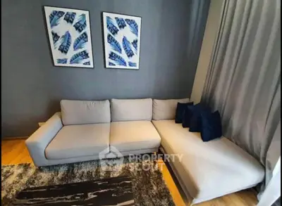 Stylish modern living room with elegant gray sofa and artistic wall decor