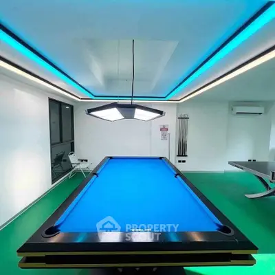 Luxurious game room with modern pool table and sleek lighting, perfect for entertainment and relaxation.
