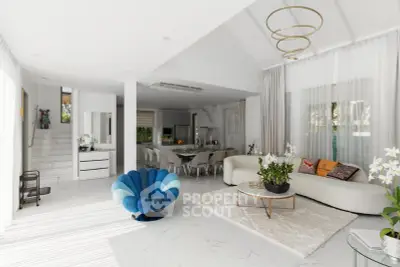 Luxurious open-plan living room with modern furniture and elegant decor, featuring a unique blue chair and plush white sofa.
