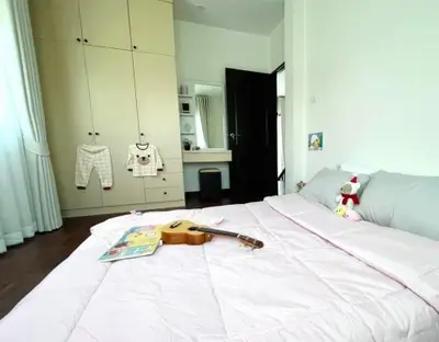 Charming bedroom with cozy decor and ample storage space, perfect for relaxation and comfort.