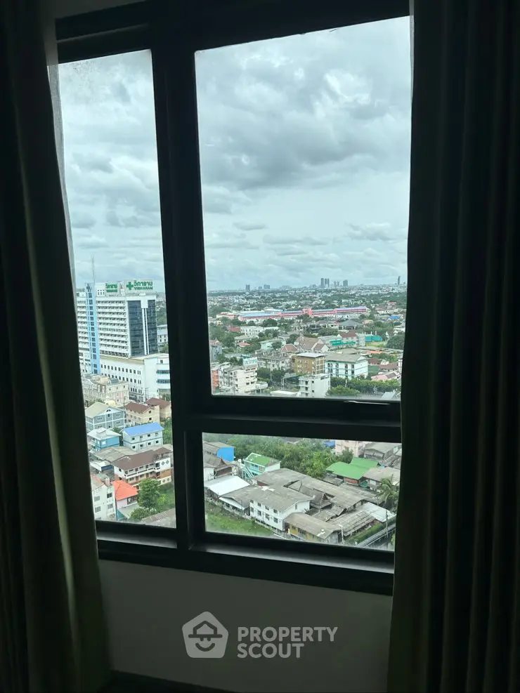 Stunning cityscape view from a high-rise apartment window, showcasing urban living at its finest.