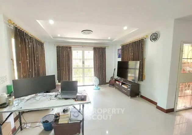 Spacious living room with modern decor and large windows for natural light.