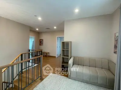 Modern interior with cozy seating area and wooden flooring, perfect for relaxation and comfort.