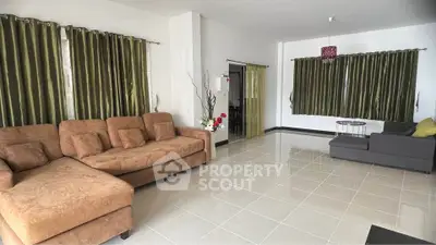 Spacious living room with modern furniture and elegant curtains