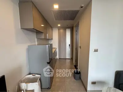 Modern kitchen with sleek cabinets and stainless steel appliances in a compact layout.