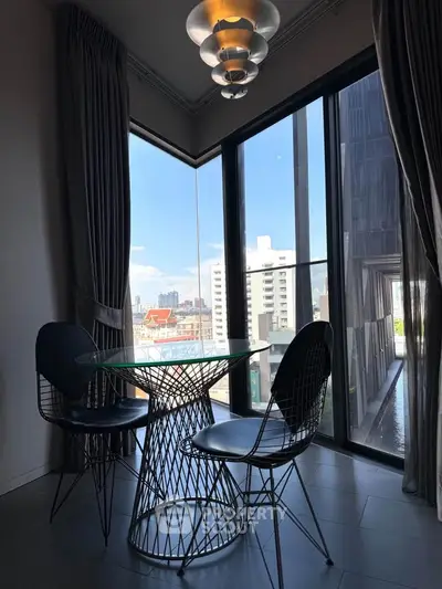 Stylish corner unit with floor-to-ceiling windows and city view, featuring modern dining set.